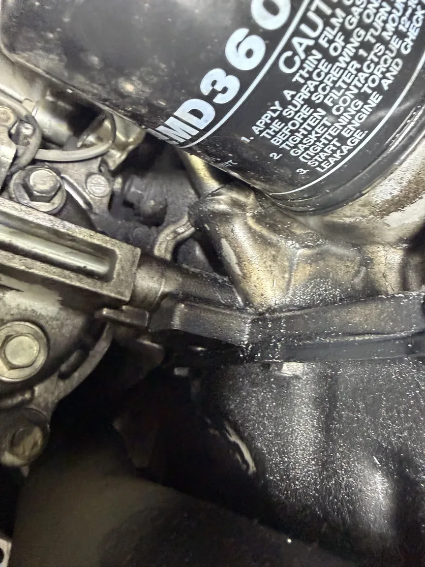 Engine oil leak evidence found during a used-car inspection